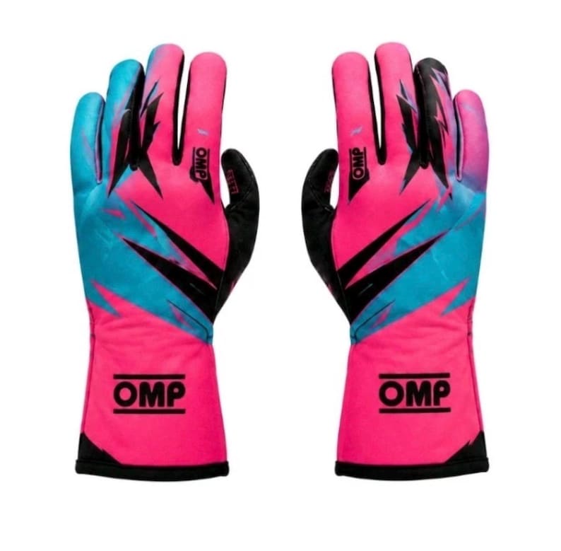 May include: A pair of racing gloves featuring a vibrant pink and bright blue abstract pattern with sharp black accents. The OMP logo is printed in black on the wrist cuff and on the back of the hand. The palms and fingers are finished in solid black.