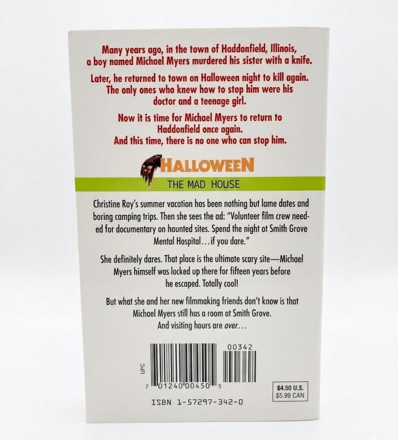 May include: The back cover of a book titled "Halloween: The Mad House", detailing a horror story about Michael Myers. The cover has a green and orange banner with the title and a knife graphic.