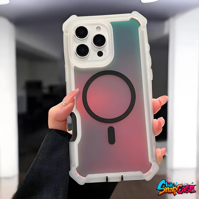 May include: A clear and white protective phone case with a gradient pink and blue design. The case has a black circular accent and a black vertical bar. The phone case has the text "Chic SnapCase" in a colorful graffiti style.