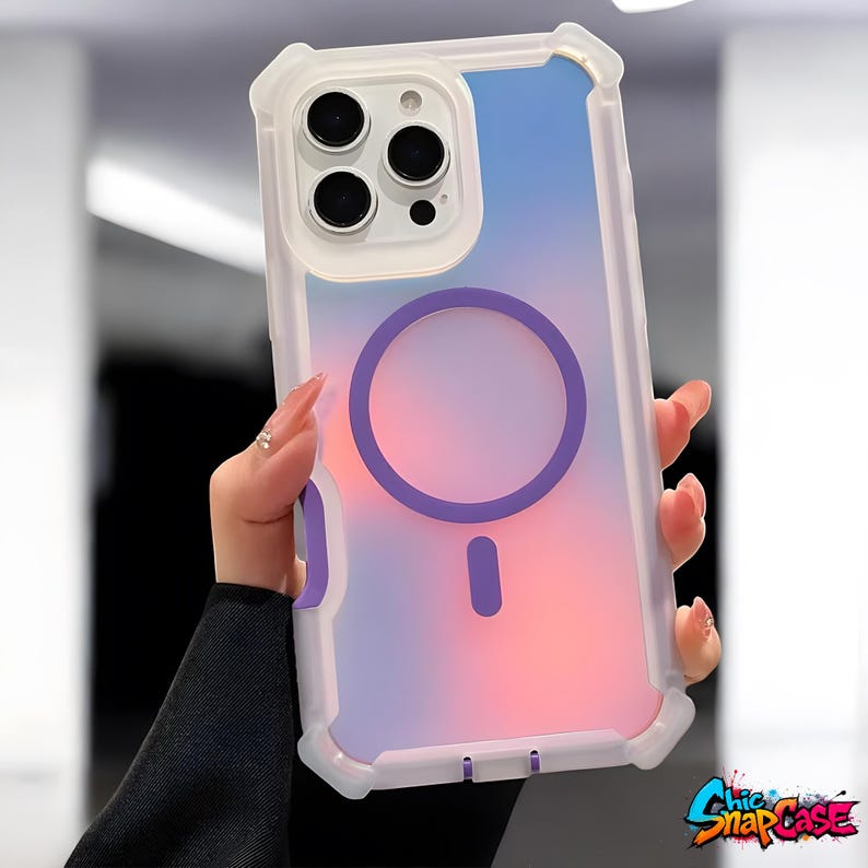 May include: Clear phone case with a gradient of pink, purple, and blue. The case has a white frame and a purple circle and dash design on the back. The case is designed to protect the phone.