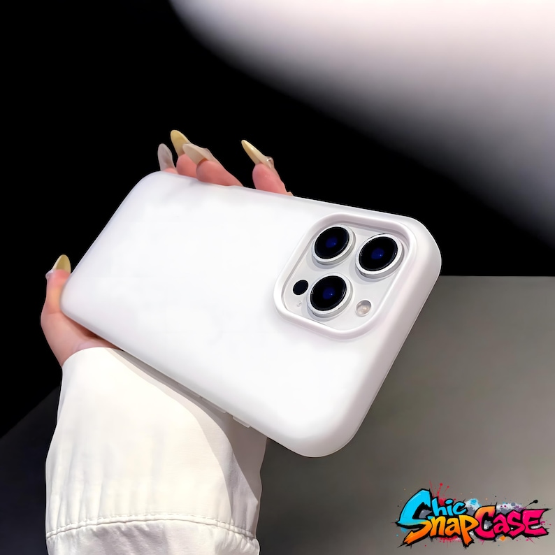 May include: A white phone case with a triple-lens camera cutout. The case has a smooth, matte finish and is designed to protect a smartphone. The Chic Snap Case logo is visible in the bottom right corner.