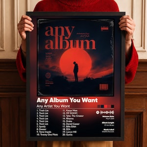 May include: A rectangular black-framed poster featuring a dark red and black gradient background. The central graphic shows a silhouette of a person standing before a large red sun. Text includes "any album," "Any Album You Want," and a track list.