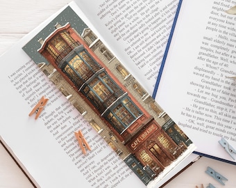 Marcapáginas en la entrada de una librería/cafetería nevada, estilo cottagecore romántico