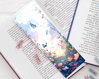Marcapáginas con campo de flores pastel, mariposas y puesta de sol