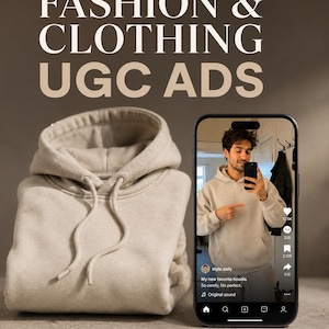 Peut inclure: Un sweat-shirt à capuche beige plié avec un cordon de serrage, placé à côté d'un smartphone affichant une vidéo sur les réseaux sociaux d'une personne portant le même sweat. Le texte FASHION & CLOTHING UGC ADS est imprimé en blanc en haut.
