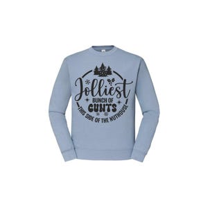 May include: A pale blue crew neck sweatshirt. The front displays a black graphic with the text "Jolliest bunch of cunts this side of the nuthouse" in a circular design with snowflakes and pine trees.