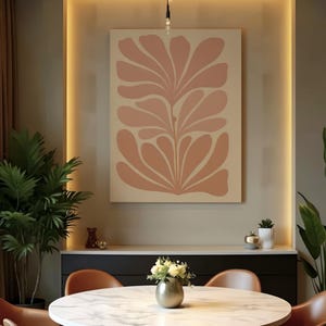 May include: A large, abstract floral art print in shades of peach and cream hangs on a neutral wall. The artwork is the focal point of a dining room setting, complemented by a round table, chairs, and decorative accents.