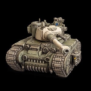 May include: A miniature scale model of a military tank painted in muted olive green and off-white tones. The tank features a central turret with a long barrel, a winged emblem on the front, heavy treads, and a small blue lens detail on the top.
