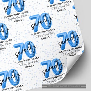 May include: White wrapping paper with a repeating pattern of blue number 70 balloons and the word "seventy" in black script. The text "Happy Birthday To A Very Special Brother Craig" is also present.