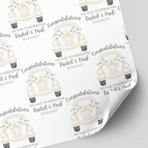 May include: Wedding-themed wrapping paper with a repeating pattern of a white vintage car adorned with flowers and bows. The text includes "Congratulations", "On Your Wedding Day", the names "Rachel & Paul", and the date "15.00.2025".