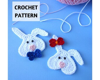 May include: Two white crochet bunny appliques with black eyes and pink noses. One bunny features a blue bow tie, while the other has a red bow on its ear. The text CROCHET PATTERN and GoldenLucyCrafts are visible on the blue background.
