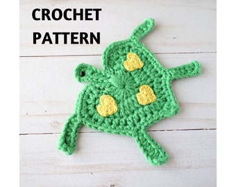 May include: Crochet pattern for a green turtle with yellow hearts. The pattern is called "GoldenLucyCrafts".