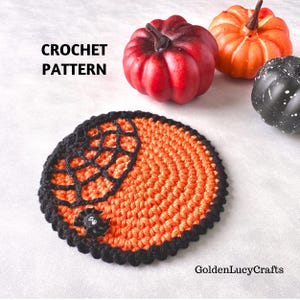 May include: A round crochet coaster featuring an orange center with a black spiderweb design on one side and a small black spider attached. The text CROCHET PATTERN and GoldenLucyCrafts are visible. Three decorative pumpkins in red, orange, and black are nearby.