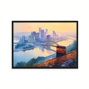 Peut inclure: Une impression encadrée d'un paysage urbain au coucher du soleil. L'image présente un téléphérique rouge montant une colline, avec un pont doré et des gratte-ciel en arrière-plan. Le ciel passe du jaune au bleu.