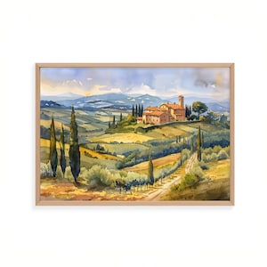 May include: A framed watercolor painting depicting a rolling landscape with a cluster of stone buildings featuring orange roofs, tall cypress trees, a winding dirt path, and distant blue mountains under a soft, light-filled sky.