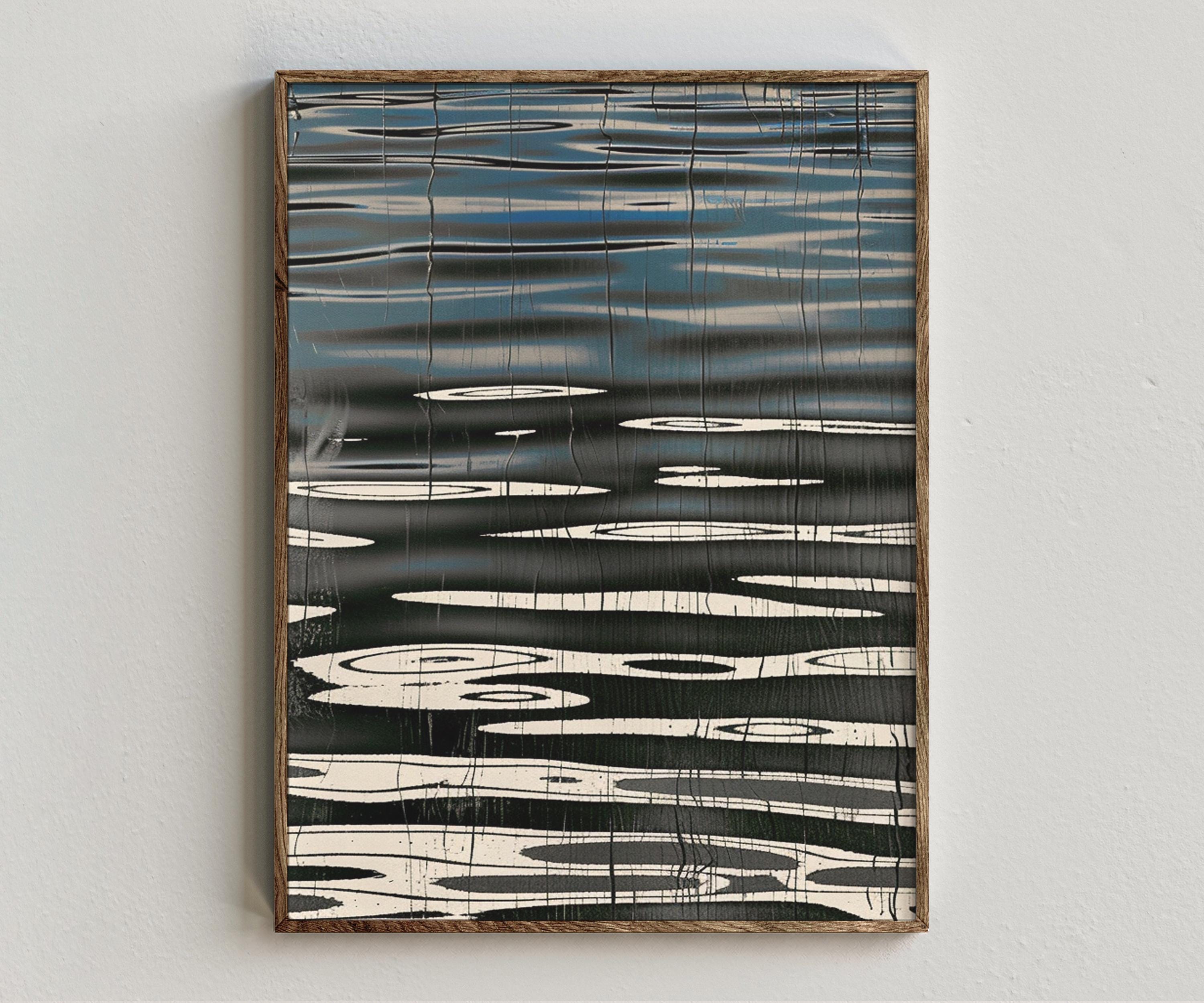 Framed artwork “Water Fold” showing blue and black abstract composition with horizontal water-like lines, reflective oval forms, and ink texture style on a white wall.