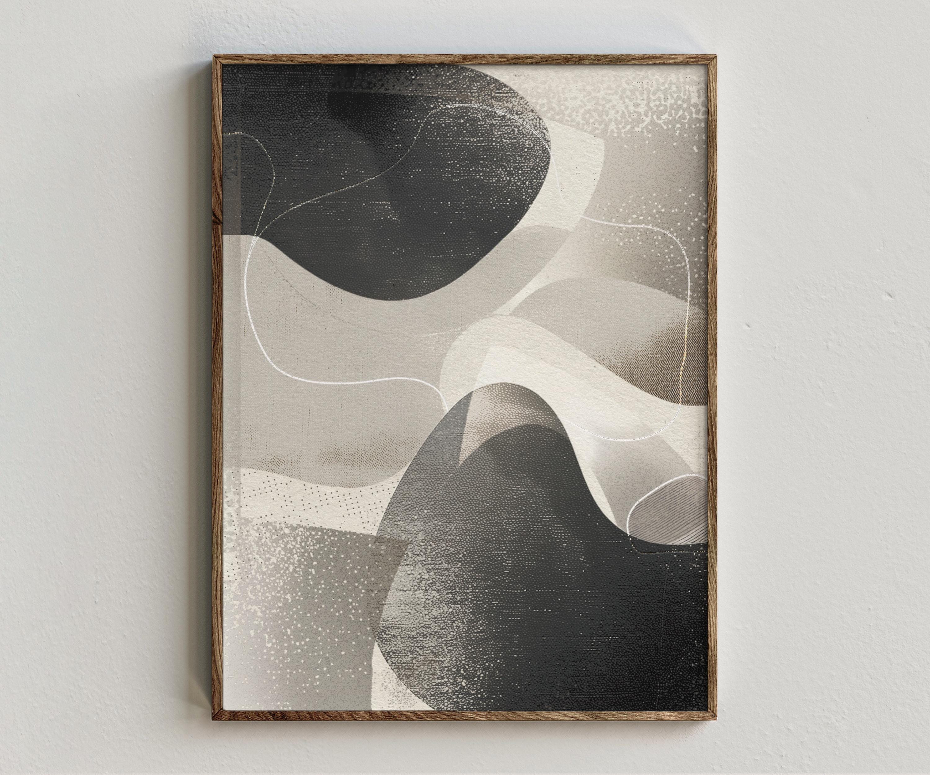 Framed artwork “Synergy” showing neutral abstract composition with layered organic forms, warm grey tones, black contrast, and textured modern style on a white wall.