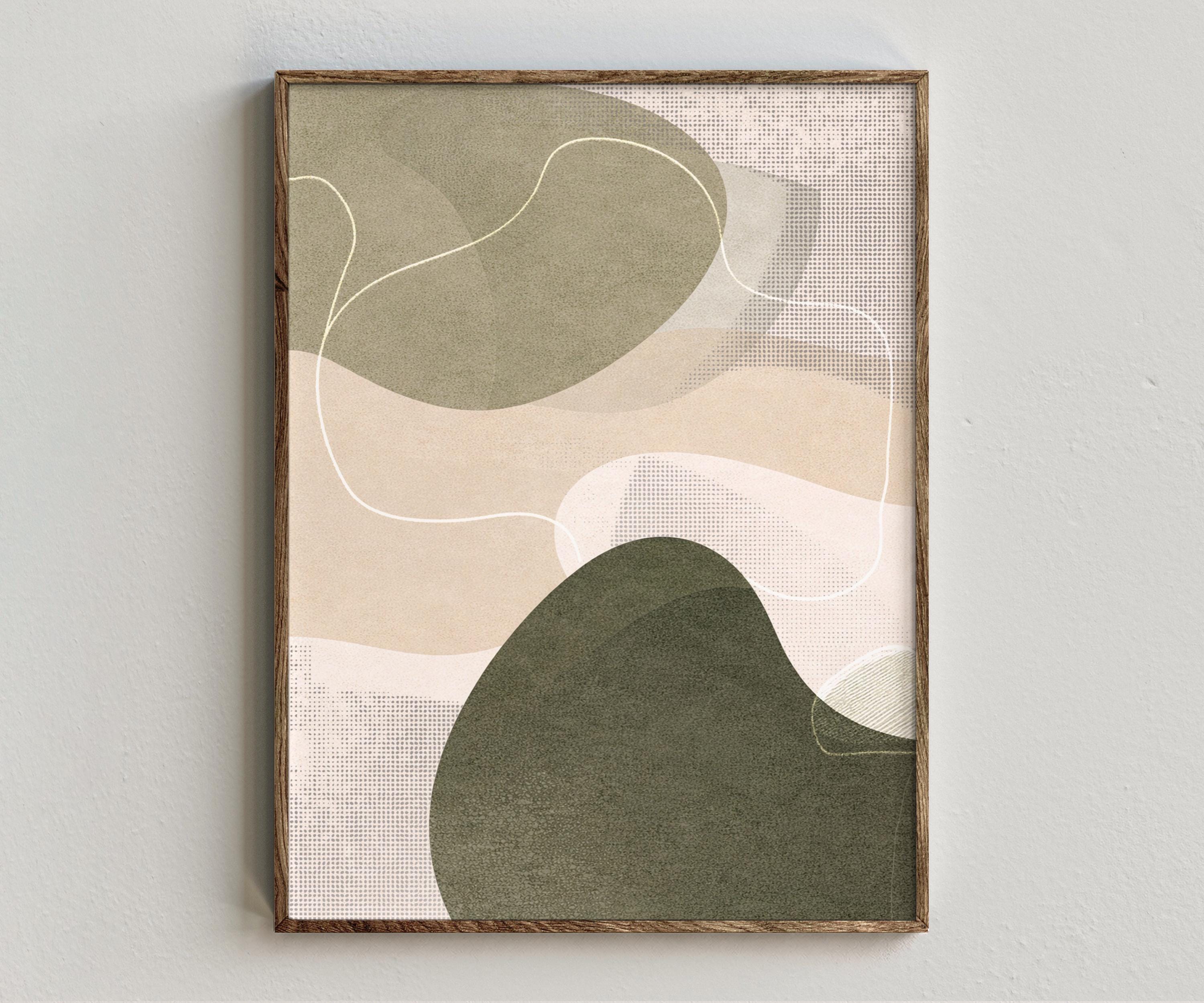 Framed artwork “Synergy - Sage” showing sage green abstract composition with muted green organic forms, warm neutral layers, white curved linework on a white wall.