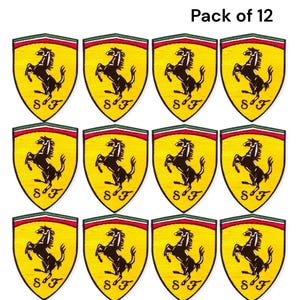May include: Twelve yellow and black Ferrari shield patches. Each patch features a black prancing horse on a yellow background, with a green and red border. The text "SF" is at the bottom of each patch. The text "Pack of 12" is at the top.