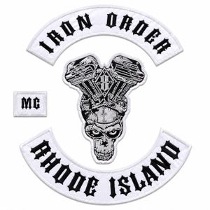 May include: A set of embroidered patches featuring a white curved top rocker with the black text IRON ORDER, a white curved bottom rocker with the black text RHODE ISLAND, a small rectangular MC patch, and a central V-twin engine and skull graphic.