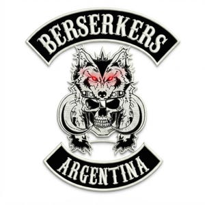 May include: A black and white embroidered patch featuring a wolf head wearing a helmet above a skull with curved tusks. The top arched banner reads BERSERKERS in white text, and the bottom arched banner reads ARGENTINA in white text.