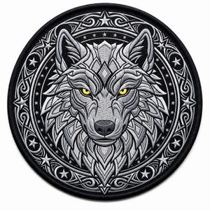 May include: A circular embroidered patch featuring a stylized wolf head in shades of silver and grey with piercing yellow eyes. The wolf is centered within a black circular border decorated with intricate silver knotwork and small white stars.