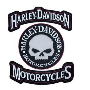 May include: A set of three Harley-Davidson patches. The top patch reads "HARLEY-DAVIDSON" in white letters on a black background with a red border. The center patch is a black circle with a skull and the words "HARLEY-DAVIDSON MOTORCYCLES". The bottom patch reads "MOTORCYCLES".