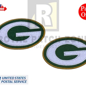 May include: Two embroidered oval patches featuring the Green Bay Packers' "G" logo in green and white, with a gold border. The patches are displayed on a white background. The image includes a "Pack of 2" label.