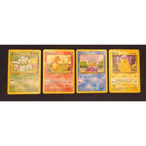 May include: Four vintage Pokémon trading cards featuring Bulbasaur, Charmander, Squirtle, and Pikachu. Each card has a yellow border and features a different Pokémon character with its name and attack details.
