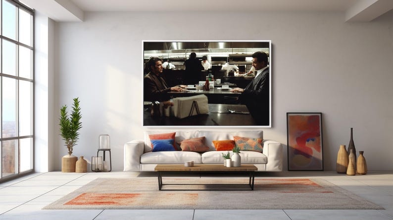 May include: A large framed print of a scene from a film hangs above a white sofa with colorful throw pillows. A wooden coffee table and a patterned rug are in front of the sofa. A tall window and decorative items complete the room.