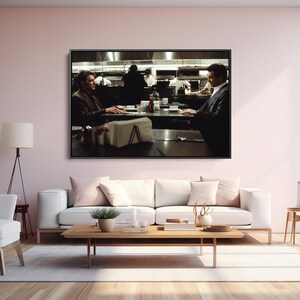 May include: A framed print of a scene from a film, depicting two people seated at a table in a restaurant. The background shows a kitchen with chefs. The room is decorated with a white sofa, a wooden coffee table, and a white armchair.