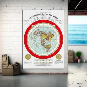 May include: A large, rectangular print of a vintage world map. The map is circular, with a red border and detailed landmasses in various colors. Text at the top reads "NEW STANDARD MAP OF THE WORLD". The print is displayed on a white brick wall.
