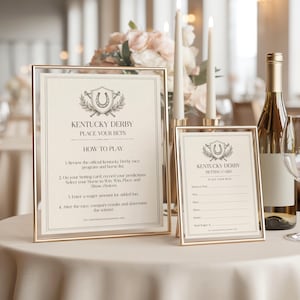 May include: Two framed Kentucky Derby betting signs with gold frames. The larger sign reads "Kentucky Derby, Place Your Bets" and "How to Play". The smaller sign is a betting card. A bottle of wine and candles are in the background.