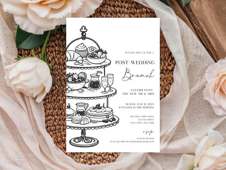 May include: Black and white post-wedding brunch invitation. The invitation features a tiered serving stand with illustrations of pastries, fruit, and drinks. Text includes "Post-Wedding Brunch" and event details. The invitation is surrounded by flowers and fabric.