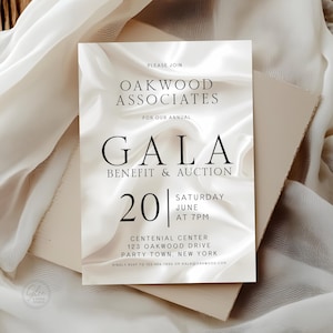 May include: A sophisticated white invitation for the Oakwood Associates Gala Benefit & Auction. The design features a flowing, silky background. Details include the date, time, and New York location.