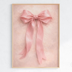 May include: A framed print featuring a large, pink bow with long, flowing ribbons. The bow is the focal point, set against a textured, blush-colored background. The artwork has a soft, romantic aesthetic, suitable for wall decor.
