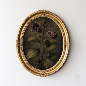 May include: An oval-shaped, ornate gold frame containing a dark, moody botanical print. The artwork depicts a central plant with deep purple bell-shaped flowers, green serrated leaves, and small dark berries against a dark, shadowed background.