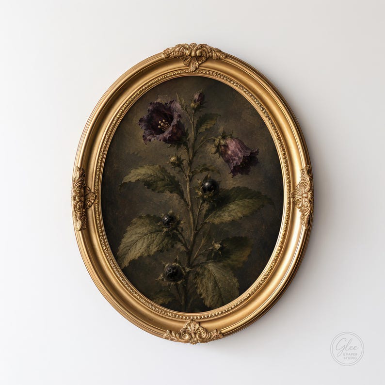May include: An oval-shaped, ornate gold frame containing a dark, moody botanical print. The artwork depicts a central plant with deep purple bell-shaped flowers, green serrated leaves, and small dark berries against a dark, shadowed background.