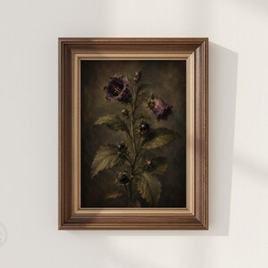 May include: A framed wall art print featuring a dark, moody botanical illustration of a plant with deep purple bell-shaped flowers and green serrated leaves. The artwork is encased in a classic, multi-toned brown wooden frame with a textured finish.