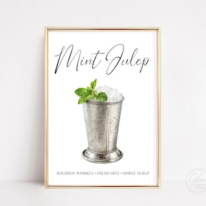 May include: A framed print featuring a watercolor illustration of a Mint Julep cocktail. The drink is in a silver cup, garnished with mint, and filled with ice. The words "Mint Julep" are written in cursive, with the ingredients listed below.