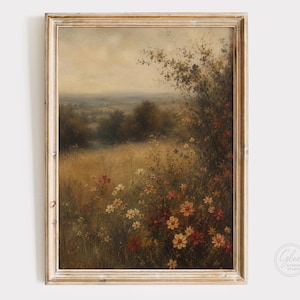 May include: A framed landscape painting featuring a field of wildflowers in shades of red, orange, and white, set against a backdrop of rolling hills and trees under a soft, overcast sky. The artwork is enclosed in a light-toned wooden frame.