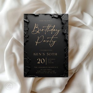 May include: A rectangular birthday party invitation card with a black center and textured black stone-like edges. The text reads: Join us for a Birthday Party, Celebrating Ken's 50th, 20 Saturday June 7:00 PM, The Anderson Residence, 125 Oak Street.