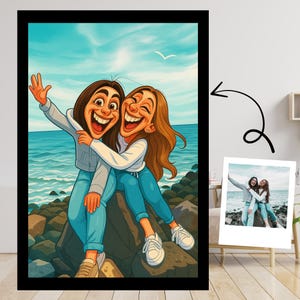 May include: A framed cartoon illustration of two smiling people hugging by the ocean. They are wearing blue jeans, white sneakers, and light-colored tops. The background features a blue sky, ocean, and rocks. A smaller photo is displayed next to the framed illustration.