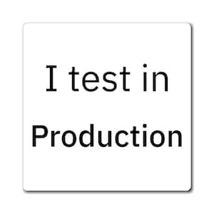 May include: A white square sticker with the black text "I test in Production". The text is centered and in a sans-serif font. The sticker has a slight shadow.