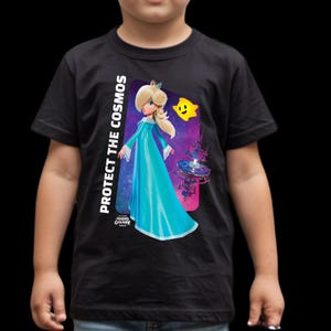May include: Black t-shirt featuring a graphic of a character in a blue gown with the text "PROTECT THE COSMOS" and a yellow star. The design is from the Mario Galaxy game.