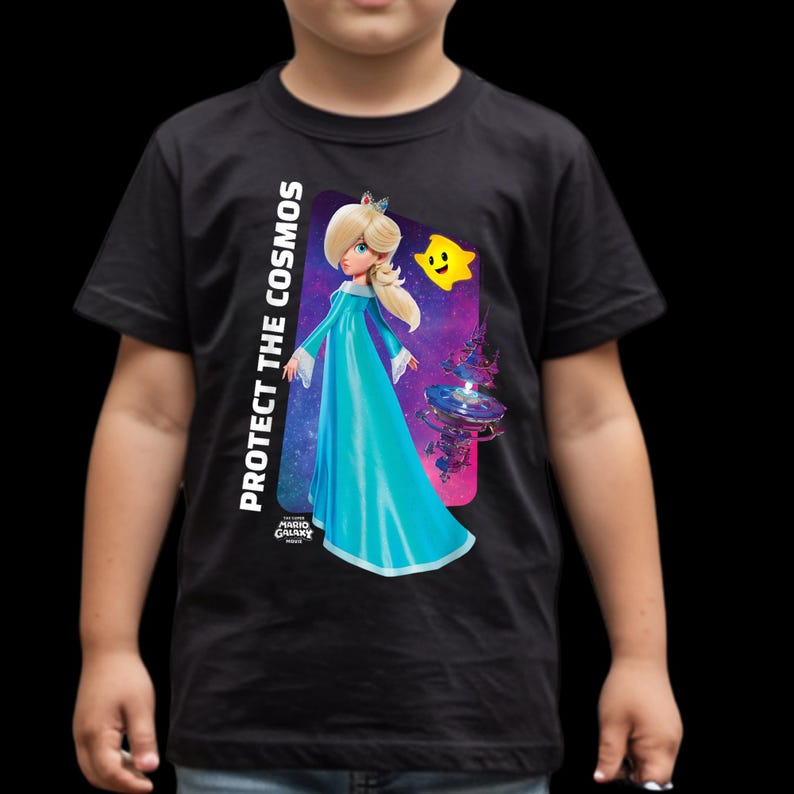 May include: Black t-shirt featuring a graphic of a character in a blue gown with the text "PROTECT THE COSMOS" and a yellow star. The design is from the Mario Galaxy game.