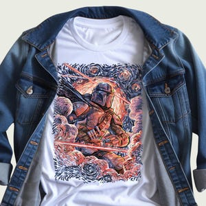 May include: White t-shirt featuring a detailed illustration of a character in armor, set against a swirling, colorful background reminiscent of a starry night. The shirt is layered under a blue denim jacket, creating a casual, layered look.