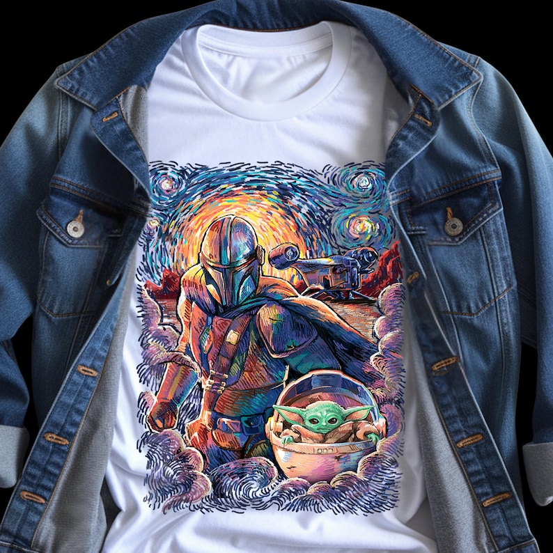May include: White t-shirt with a colourful illustration of The Mandalorian and Grogu, set against a starry night sky. The artwork is reminiscent of Van Gogh's style, with swirling brushstrokes and vibrant colours. The shirt is paired with a denim jacket.