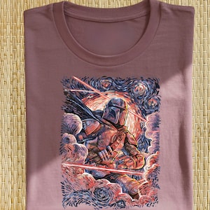 May include: Mauve t-shirt featuring a stylized illustration of a character in armor, with a helmet and cape, amidst swirling clouds and laser beams. The artwork has a painterly style with a starry night sky background.