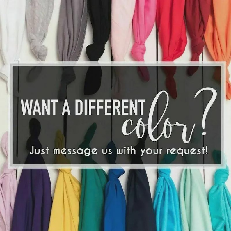 May include: A variety of colorful t-shirts are displayed against a white wooden background. The image features a sign that reads "WANT A DIFFERENT color?" and "Just message us with your request!"